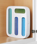 StoraBag Drawer Food Bags Dispenser with 4 slots shown in a kitchen cabinet, filled with colorful storage bags, easy load top lid visible.