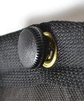 Detail of a black sound dampening blanket button for the Ditch Junky Foam For This Top Shelf Sound Absorption Sheet.