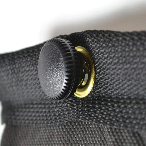 Detail of a black sound dampening blanket button for the Ditch Junky Foam For This Top Shelf Sound Absorption Sheet.