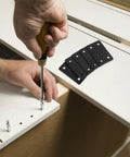Person using screwdriver with Six Pack Stainless Steel Straight Mending Plates for wood furniture repair visible beside