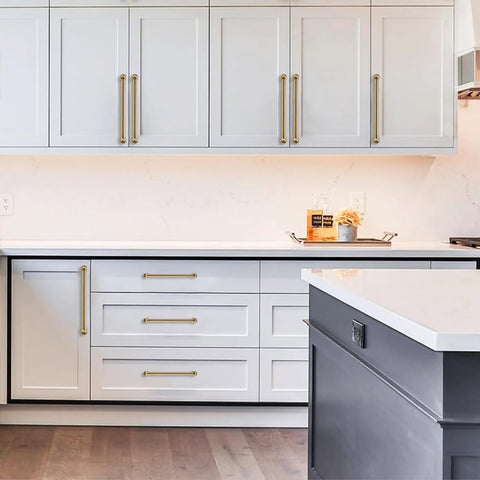10 Pack 3-Inch Solid Zinc Alloy Cabinet Handles Brushed Gold Finish With Satin Brass Accents installed on white kitchen cabinets
