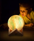 Child admiring Moon Lamp Galaxy Night Light 5.9 Inch with 16 Colors LED 3D Moon Surface, Remote Control and Touch Sensor glowing