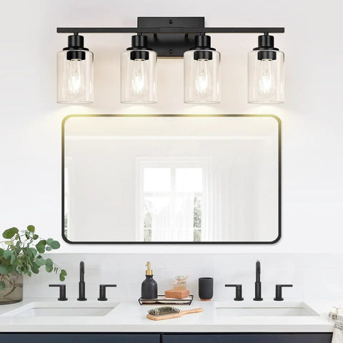 Sleek Matte Black Four Light Bathroom Vanity Wall Lamp With Thick Clear Glass Shades For Mirror Or Porch, mounted above white sink.