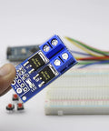 12 Pack High Power MOSFET Trigger Switch Drive Module 5V-36V DC PWM Controller held in hand with wires and breadboard in background
