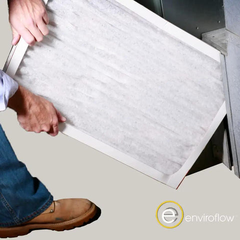 Person installing Pleated Replacement Air Filter for AC and Furnace 21.5 by 23.5 Inches Pack of 4 MERV 8 Pollen and Dust Control