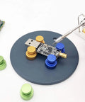Magnetic Welding Bracket Set Soldering Holder with metal fixing plate for PCB repair, showing adjustable magnetic brackets on a workstation.