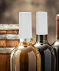 Snag These White PVC Heat Shrink Wine Bottle Caps A Dope One Hundred Pack To Keep Open Bottles Fresh With An Airtight Seal That Kills Oxidation Cold Zero Fuss Just Heat For A Snug Fit Around Any Neck Sweet For Weekend Sipping Or Quick Stashing. Two wine bottles with white PVC heat shrink caps on necks.