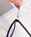 Person using screwdriver to attach arm with DIY Glasses Temple Replacement Arms Kit With Screws, Washers, Screwdriver And Nose Pads TR90 Eyeglasses Repair Set In Black Easy Install All-In-One Eyewear Fix Kit Great For DIYers And Pros, Includes Durable TR90 Arms For Comfy Wear