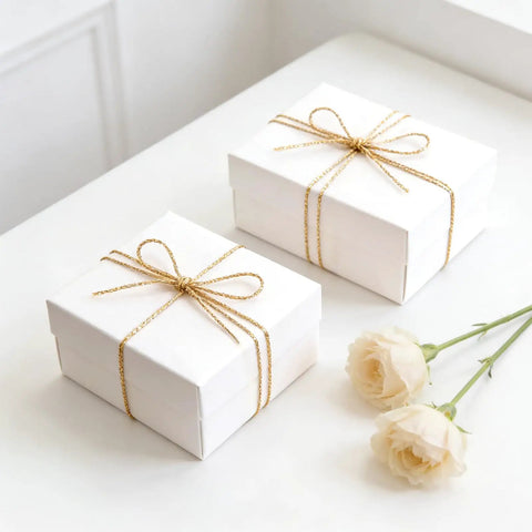 Decorative Metallic Bakers String Gold Twine 110 Yards 1.5mm Inelastic Glitter String on white gift boxes with roses