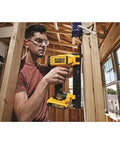 Man using 20V Cordless Stapler Kit For Cables With Center LED Light, Extended Trigger For Easy Use In Any Angle on wood frame