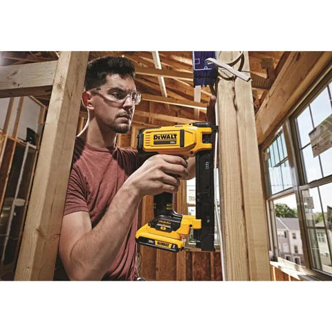 Man using 20V Cordless Stapler Kit For Cables With Center LED Light, Extended Trigger For Easy Use In Any Angle on wood frame