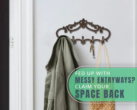 Knockout Five Hook Cast Iron Wall Hanger In Rustic Brown Fleur De Lis Farmhouse Entryway Coat Rack holding a green jacket and bag.