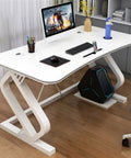 Modern White Gaming Desk Featuring A Built In Phone Slot And Side Storage Shelf, Ergonomic Arc Edge Layout For Smooth Typing, Hella Durable Pc Workstation Ideal For College Rooms Or Epic Gaming Setups with a computer and accessories.