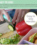 Front view of Melii stainless steel crinkle cutters with teal handle; slicing cucumber on a cutting board (3-pack).
