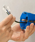 ANCIRS ceramic wire connectors; white caps on brown, blue, and green-yellow wires near a blue round electrical box