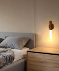 Wooden Motion Sensor Night Lights With Magnetic Body Sensor Dual Mode LED Light for hallways and stairs mounted beside bed.