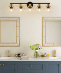 Mid Century Modern Bathroom Vanity Light Fixture With Clear Globe Glass Shades Five Light Black And Brass Gold Wall Sconce Over Mirror 36 Inch Vintage Style Bath Lighting Bulbs Not Included shown over double sink and mirrors