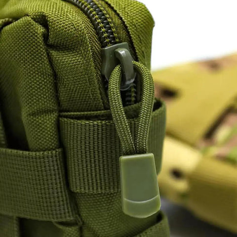 Close-up of green nylon zipper pull on bag, part of 16 Pack Heavy Duty Zipper Pull Replacements For Luggage Backpacks Jackets And Purses Universal Zipper Tag Extender Repair Kit Built From Durable Nylon Cord With Wear Resistant Pull Tabs In Assorted Colors.