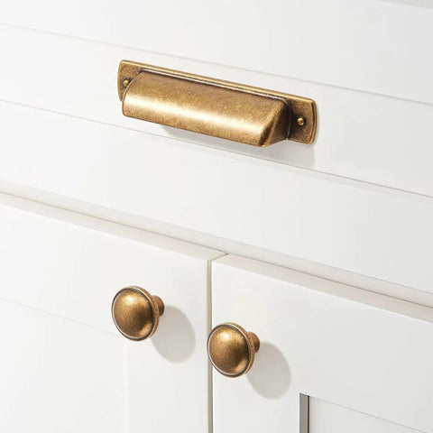 Ten Pack Vintage Cabinet Pulls In Antique Brass With Four Inch Center To Center Spacing And Five And A Half Inch Overall Length Zinc Alloy Kitchen Hardware Drawer Handles Cup Knobs Set For Cabinets And Furniture installed on white cabinet doors.