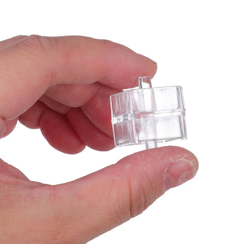 Tape Dispenser Spindle Adapters Plastic Replacement Axles Bundle For Quick No Hassle Tape Replacements Compact And Easy To Install Core Roller Spare Parts To Keep Your Desk Neat And Rolling. clear plastic tape dispenser spindle adapter held between fingers