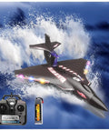 Black RC airplane flying over waves with remote and battery pack