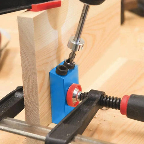 Close-up of Carpentry Locator Jig For 15 Degree Dowel Drilling Kit in action on wood block with drill bit inserted.