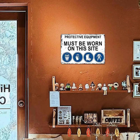 12 X 8 Inch Aluminum Safety Sign Must Wear Protective Equipment On This Site displayed on a wall in a room with shelves