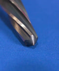 Close-up of tapered point of 7/8 Inch Bridge Construction Reamer With Magnetic Hex Shank for bolt or rivet prep on blue fabric.