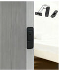 Hidden Bookcase Hinges With Lock And Magnetic Latch, black zinc alloy door installed, 304 stainless steel hardware visible