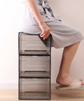 Person sitting on stack of three Six Pack See Through Storage Boxes With Acrylic Magnetic Doors For Closet Organization, clear plastic.