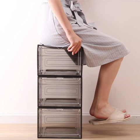 Person sitting on stack of three Six Pack See Through Storage Boxes With Acrylic Magnetic Doors For Closet Organization, clear plastic.