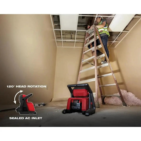 Beast Dual Power 4000 Lumen LED Flood Light With Corded And Cordless Operation on job site with worker on ladder