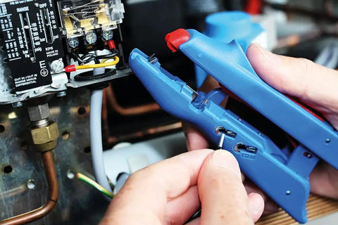 Hands using 3-In-1 Automatic Wire Stripper And Ferrule Crimper with Side Cutter for 10-20 AWG on electrical panel.