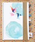Spiral notebook with watercolor butterflies and kraft paper cover on polka dot background