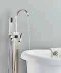 Pro Grade Floor Mount Tub Filler Freestanding Bathtub Faucet With Brushed Nickel Finish next to white bathtub.