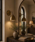 Mid Century Modern Brass Wall Sconces Set of 2, wall light fixtures illuminating a stylish room with plants and decor.