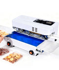 Rock Solid Commercial Heat Sealer Machine With Digital Temperature Control sealing snacks with adjustable speed on a blue tray.
