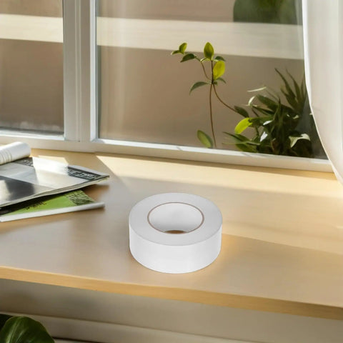 No Gimmicks Solid Grip Clear Double Sided Tape For Wall Mounting And DIY Fixes Weather Proof on a wooden surface near a window.