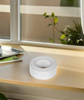 Super Smooth Removable Double Sided Tape 5Cm X 164Ft Transparent Pet Roll displayed on a wooden desk near a window.
