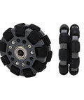 Robot omniwheel tire, 100 mm, black segmented rubber rollers around gray hub with bearing, front view