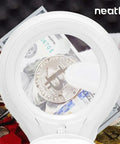 LED Bifocal Magnifying Lamp With 1,200 Lumens, Dual 2.25X And 6X Magnification, 5 Inch Glass Lens focusing on coins