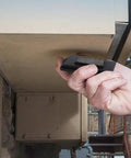 Hand placing a black 3-Pack Magnetic Key Lock Box Set With Strong Magnets For Car Home And Outdoor Use Hide A Spare Key under an outdoor surface.