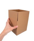 Hand holding a 15 Pack Square Corrugated Shipping Boxes 15x15x15 CM Heavy Duty Cartons for mailing and packing
