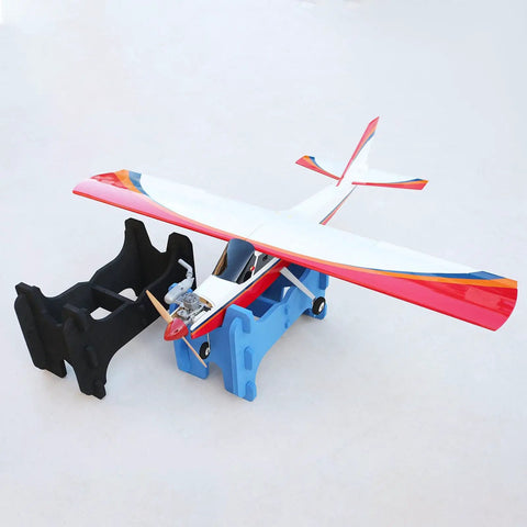 Double Slot RC Aircraft Foam Stand For Gas Powered And Electric Planes, black foam stand holding a red and white RC airplane