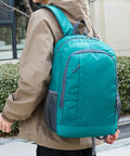 Ultra Light Packable Daypack For Travel And Hiking With Water-Resistant Nylon shown on person outdoors, green.