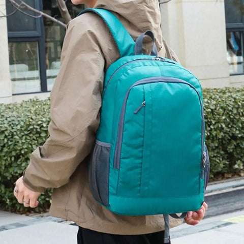 Ultra Light Packable Daypack For Travel And Hiking With Water-Resistant Nylon shown on person outdoors, green.