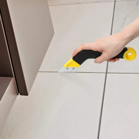 Hand using Grout Removal Tool Kit With Angled Saw Blade And 3 Extra Replacement Blades No Fuss Grout Ripper on tile joint