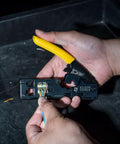 Hands using Go To Compact Ratcheting Data Cable Crimper Wire Stripper Cutter for CAT3 CAT5e CAT6 RJ45 RJ11 RJ12 Connectors
