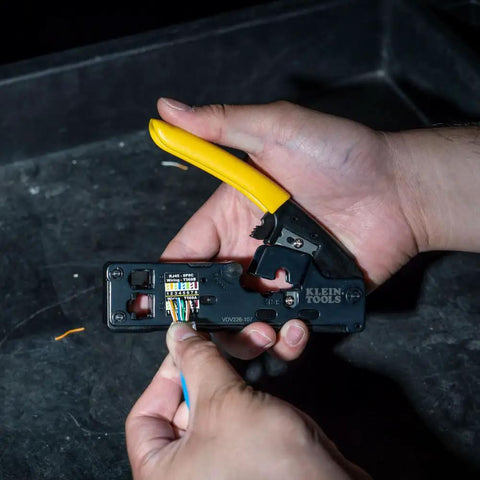 Hands using Go To Compact Ratcheting Data Cable Crimper Wire Stripper Cutter for CAT3 CAT5e CAT6 RJ45 RJ11 RJ12 Connectors