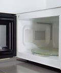 Open microwave showing installed 12 Pack Microwave Mica Plates Heat Resistant Insulation Sheets Anti Oil Film Fireproof Pads in kitchen.